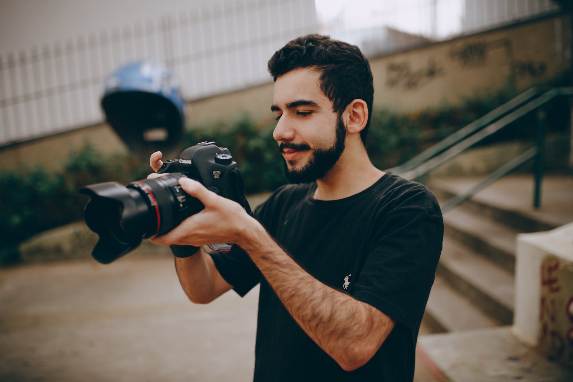 photo of man taking photo using a dslr camera